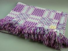 A PURPLE AND PINK LARGE WELSH WOOLLEN BLANKET with tasselled ends, original label 'Made in Wales,