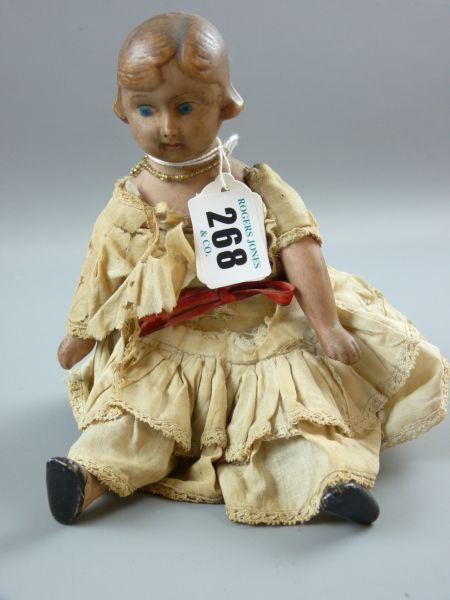 A BISQUE HEADED DOLL, cloth bodied, head and shoulder plate doll with molded hair limbs and