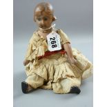 A BISQUE HEADED DOLL, cloth bodied, head and shoulder plate doll with molded hair limbs and