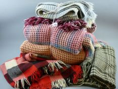 FOUR WELSH WOOLLEN WAFFLE BLANKETS and two tassel edged woollen throws, various designs and colours