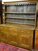 A LATE 18TH CENTURY OAK WELSH DRESSER, the three shelf rack with decorative fretwork apron and