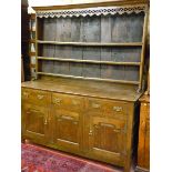 A LATE 18TH CENTURY OAK WELSH DRESSER, the three shelf rack with decorative fretwork apron and