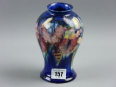 A MOORCROFT ORCHID VASE, a 16 cms waisted form vase decorated on a cobalt blue ground, signature