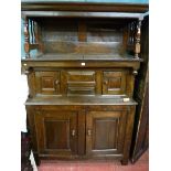 AN 18TH CENTURY WELSH OAK CWPWRDD TRIDARN having a hooded top with cornice and turned pillars over a