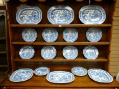 A GOOD SET OF WILLOW PATTERN DRESSER PLATES comprising six meat plates and seventeen dinner