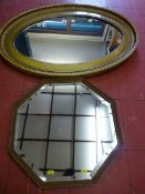 A GILT FRAMED OVAL WALL MIRROR and one other, 85 x 57 cms the largest