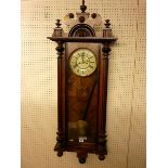 A VIENNA STYLE WALL CLOCK, late 19th Century walnut and ebonized wall clock, twin weight pendulum