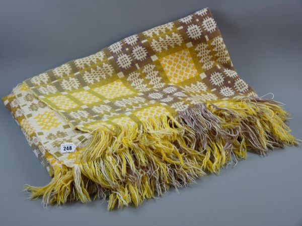 A YELLOW PATTERNED WELSH WOOLLEN BLANKET with tasselled ends