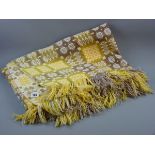 A YELLOW PATTERNED WELSH WOOLLEN BLANKET with tasselled ends