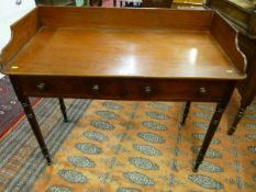 A VICTORIAN MAHOGANY TWO DRAWER WASHSTAND, a 5 ins shaped gallery over a single board top, two