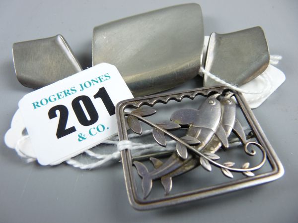 A GEORG JENSEN PIN BROOCH, a near square silver pin brooch featuring two leaping dolphins over a