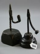 TWO ANTIQUE AND LATER RUSH LIGHT HOLDERS, an 18th Century possibly West Country example driven