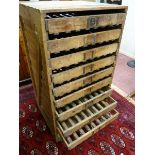 A VINTAGE PINE APPLE STORAGE RACK by E H Taylor Ltd, nine slide-out slatted base drawers within a