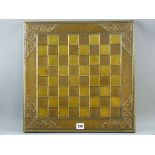 A CHESS BOARD IN THE ARTS & CRAFTS STYLE a copper and brass chess board decorated with floral