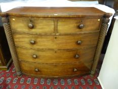 A VICTORIAN MAHOGANY BOW FRONT CHEST OF DRAWERS of two short over three long drawers with turned