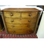 A VICTORIAN MAHOGANY BOW FRONT CHEST OF DRAWERS of two short over three long drawers with turned