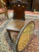 A MAHOGANY HALL CHAIR AND AN OVAL MIRROR, Victorian leaf carved back with raised shield centre,