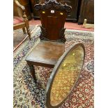 A MAHOGANY HALL CHAIR AND AN OVAL MIRROR, Victorian leaf carved back with raised shield centre,