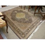 A FINE MAHI TABRIZ PERSIAN CARPET, muted colours with central medallion and floral inner border,