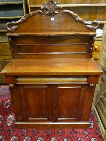 A NEAT VICTORIAN MAHOGANY CHIFFONIER, carved and panelled back with shaped shelf over a