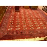 A PRADO ORIENT KESHAN SUPER CARPET, red ground multi repeat pattern with wide border and tasselled