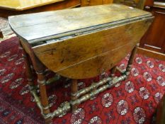 AN 18TH CENTURY AND LATER OAK GATE LEG TABLE with single end drawer front (drawer lining missing) on