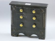 AN EXCELLENT SLATE MODEL OF A CHEST OF DRAWERS with carved front decoration flanking two short and