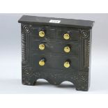 AN EXCELLENT SLATE MODEL OF A CHEST OF DRAWERS with carved front decoration flanking two short and