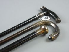 THREE SILVER TOPPED WALKING CANES, two ebony examples and one other with cased silver handle, all