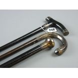 THREE SILVER TOPPED WALKING CANES, two ebony examples and one other with cased silver handle, all