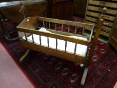 A BABY'S WOODEN ROCKING CRADLE nineteenth century and later European oak and walnut cradle with