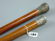 TWO MALACCA WALKING CANES, Indian silver topped and Chinese silver topped, 94 and 86 cms