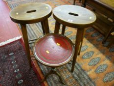 A PAIR OF OVAL TOPPED WOODEN BAR STOOLS, 64 cms high and a reproduction wine table