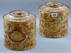 A PAIR OF PARKINSON'S TOFFEE TINS, canister shaped with lids with Eastern style panels and floral