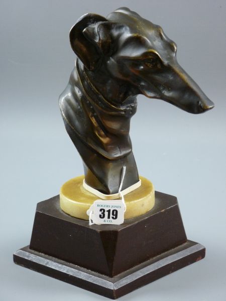 A CONTEMPORARY BRONZE BUST OF A GREYHOUND'S HEAD, mounted on an alabaster and wooden plinth, 27