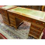 A YEW WOOD TWIN PEDESTAL DESK AND MATCHING FILE CABINET, gilt tooled green leather top over three