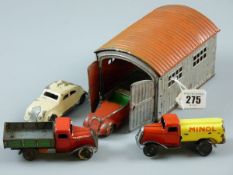 FOUR LEHMANN GNOM TINPLATE VEHICLES with a red roofed tinplate garage, the vehicles with standard