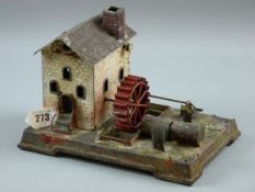 A TINPLATE WATER MILL, a German tinplate model of brick building with spoked water wheel to