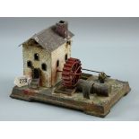 A TINPLATE WATER MILL, a German tinplate model of brick building with spoked water wheel to