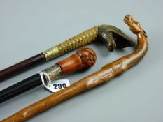 THREE VINTAGE WALKING CANES, ebony shaft with silver ferrule and Oriental wood carved rats grip,