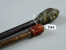 TWO VINTAGE WALKING CANES one with cast metal head of an old woman, the other a briar wood example