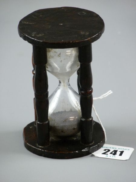 A TREEN EGG TIMER, an early example having four simply turned pillars with early glass sand
