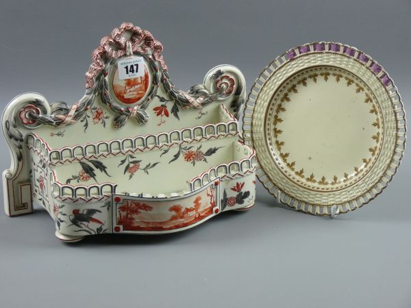 A FAIENCE LETTER RACK AND CREAMWARE PLATE, a hand painted double section letter rack with bird and