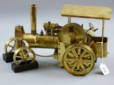 A BRASS MODEL TRACTION ENGINE STEAM TRAIN, steered model with front wheel chocks, marked to the base