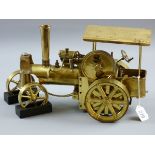 A BRASS MODEL TRACTION ENGINE STEAM TRAIN, steered model with front wheel chocks, marked to the base