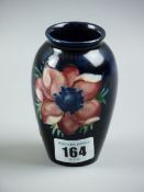 A MOORCROFT ANEMONE VASE, a 10.5 cms high vase decorated on a cobalt blue ground, impressed '