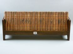 PUNCH LIBRARY OF HUMOUR CIRCA 1900, twenty five volume set in an oak table top book rack, 64.5 cms