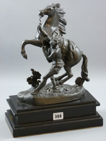 A SPELTER MARLEY HORSE, a rearing figure of a horse with handler on a stepped black marble