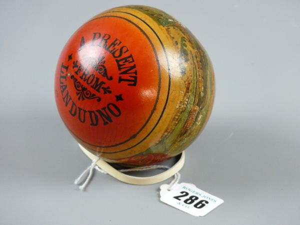 A VINTAGE PRESENT FROM LLANDUDNO RUBBER BALL, late 19th/early 20th Century with printed scenes of