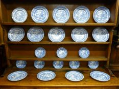 A SET OF WILLOW PATTERN DRESSER PLATES, fourteen dinner plates and eight side plates as displayed on